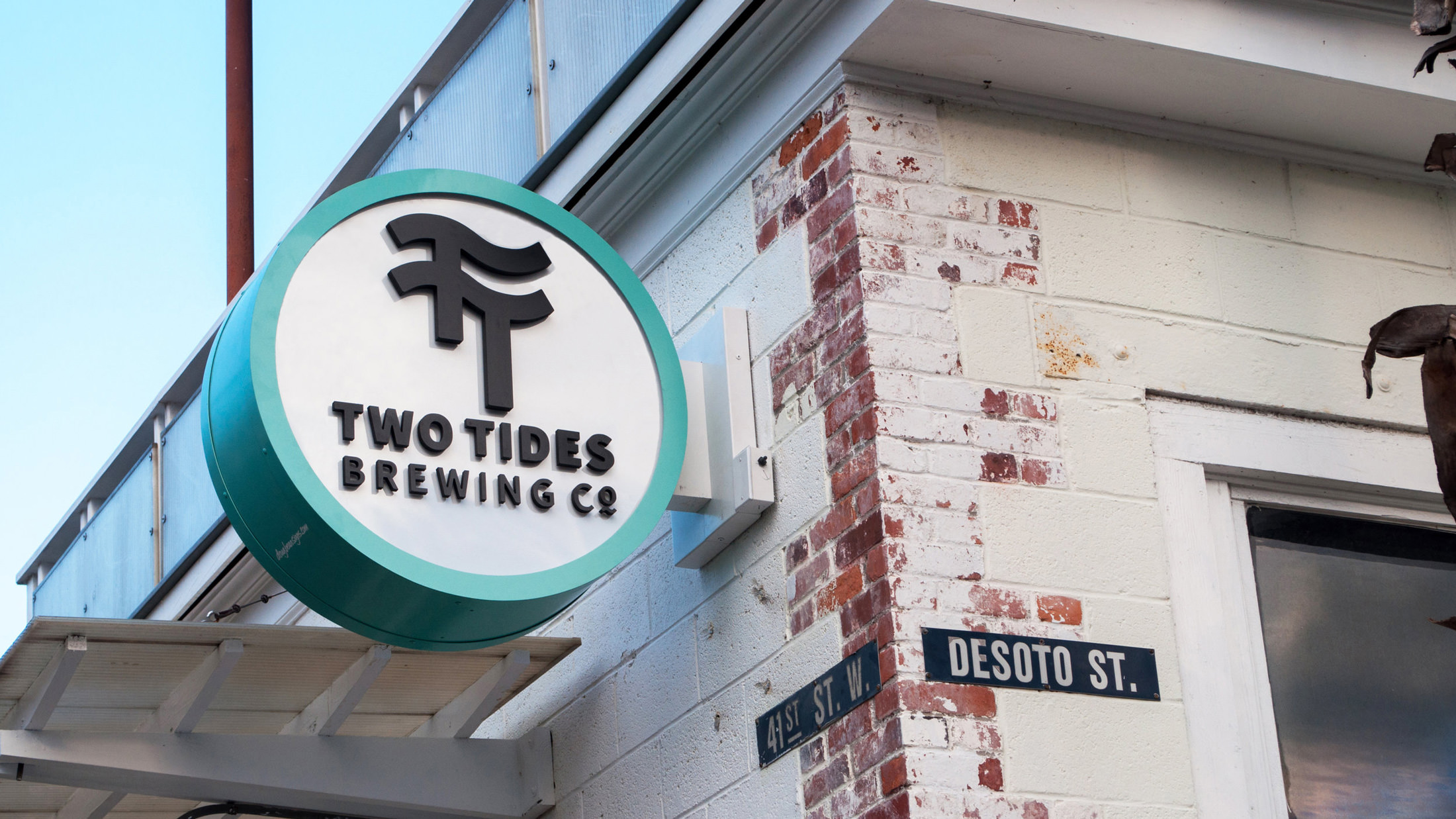 Poster image showing the exterior sign for Two Tides Brewing Co.
